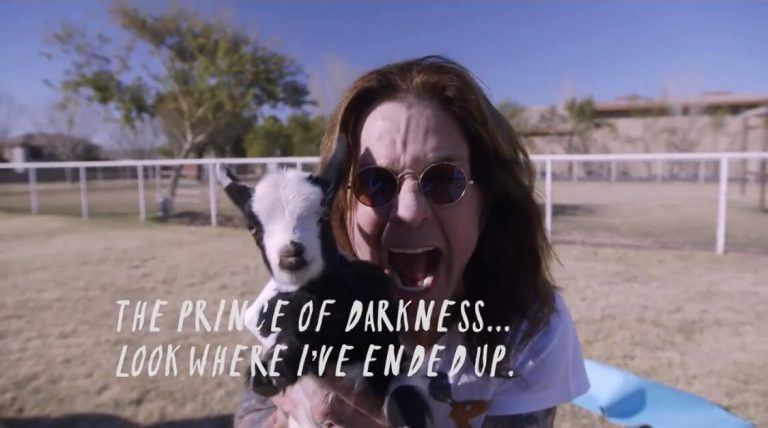 Ozzy Osbourne holding baby goat at Arizona Goat Yoga